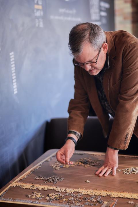 Jonathan working on a puzzle in the community space.