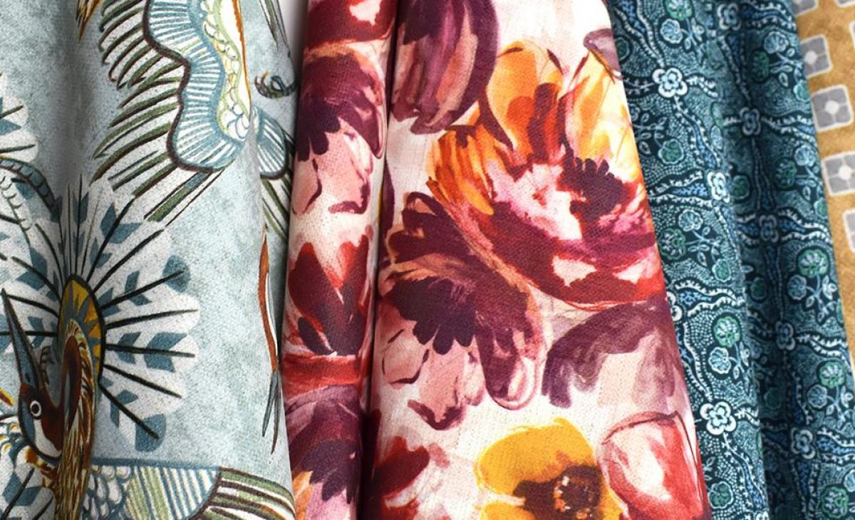 swaths of brightly colored floral and geometric patterned fabrics