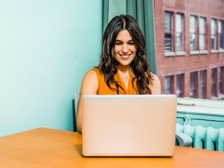 Woman smiling at laptop