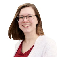 Ashley head and shoulders, with glasses, brown hair, and burgundy shirt with cream cardigan