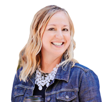 Lisa head and shoulders, with blonde hair, denim jacket, and chunky white necklace