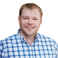 Sam head and shoulders, with blonde hair and white and blue plaid shirt