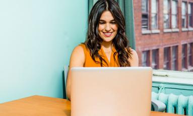 Woman smiling at laptop